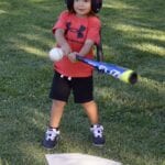 young girl about to hit a ball