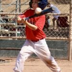 kid hitting a baseball ball