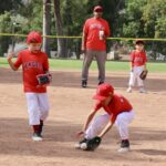 kids in red uniform catching a ball