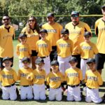 baseball team in yellow uniform posing for a picture
