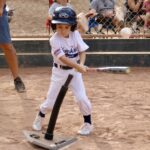 kid practicing hitting a ball with a bat