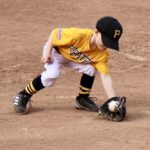 kid catching a ball with a baseball glove