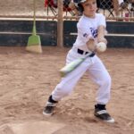 boy about to hit a ball with a bat