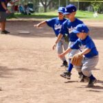 boys in blue shirts playing baseball