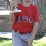kid in red shirt holding a trophy